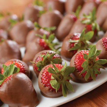 Choice strawberries dipped in Dutch chocolate and arranged on a platter.