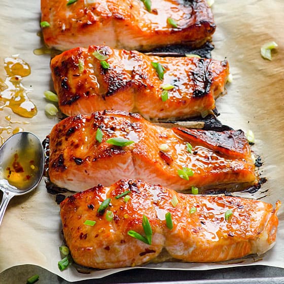 4 cooked salmon fillets with teriyaki glaze and green onions